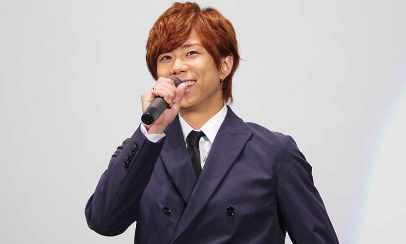 北山宏光がスーツを着てマイクを持っている画像